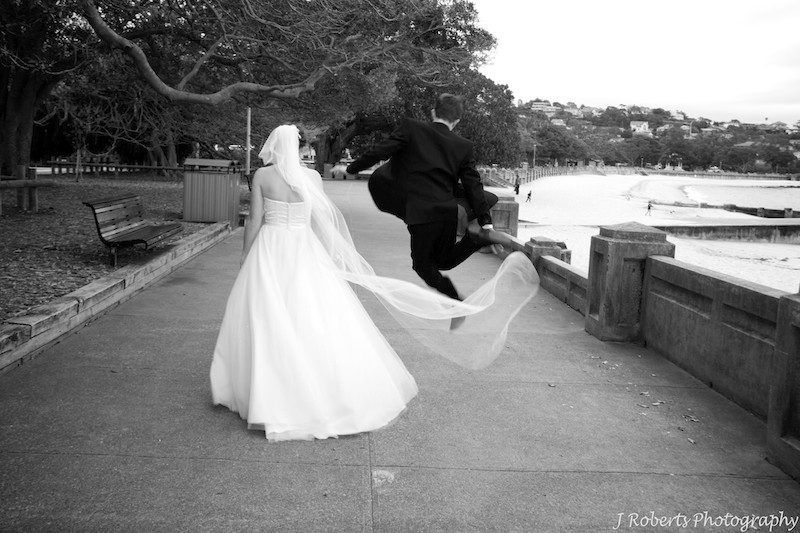 Groom jumping for joy Balmoral Beach - wedding photography sydney